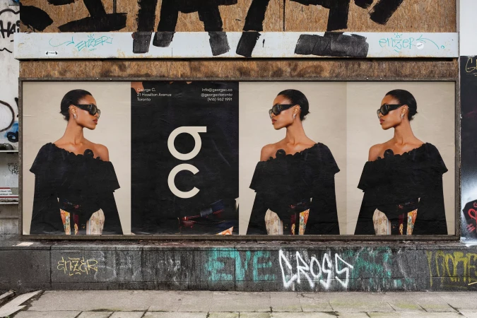Outdoor poster featuring a woman with sunglasses and a black dress, set against an urban backdrop with graffiti and architectural elements.