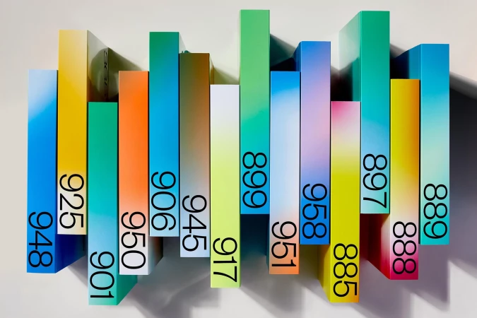 Abstract view of colorful rectangular blocks with gradient colors and numbers in an overhead studio shot on white background.