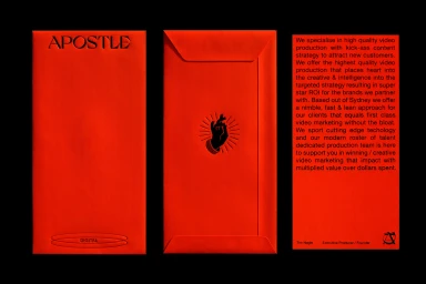 Red envelope stationery branding with embossed typography and a hand illustration against a solid black background.