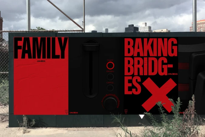 A black and red outdoor advertising display showcasing a graphic with the words 'Family', 'Baking', and 'Bridges' set against a cloudy sky.