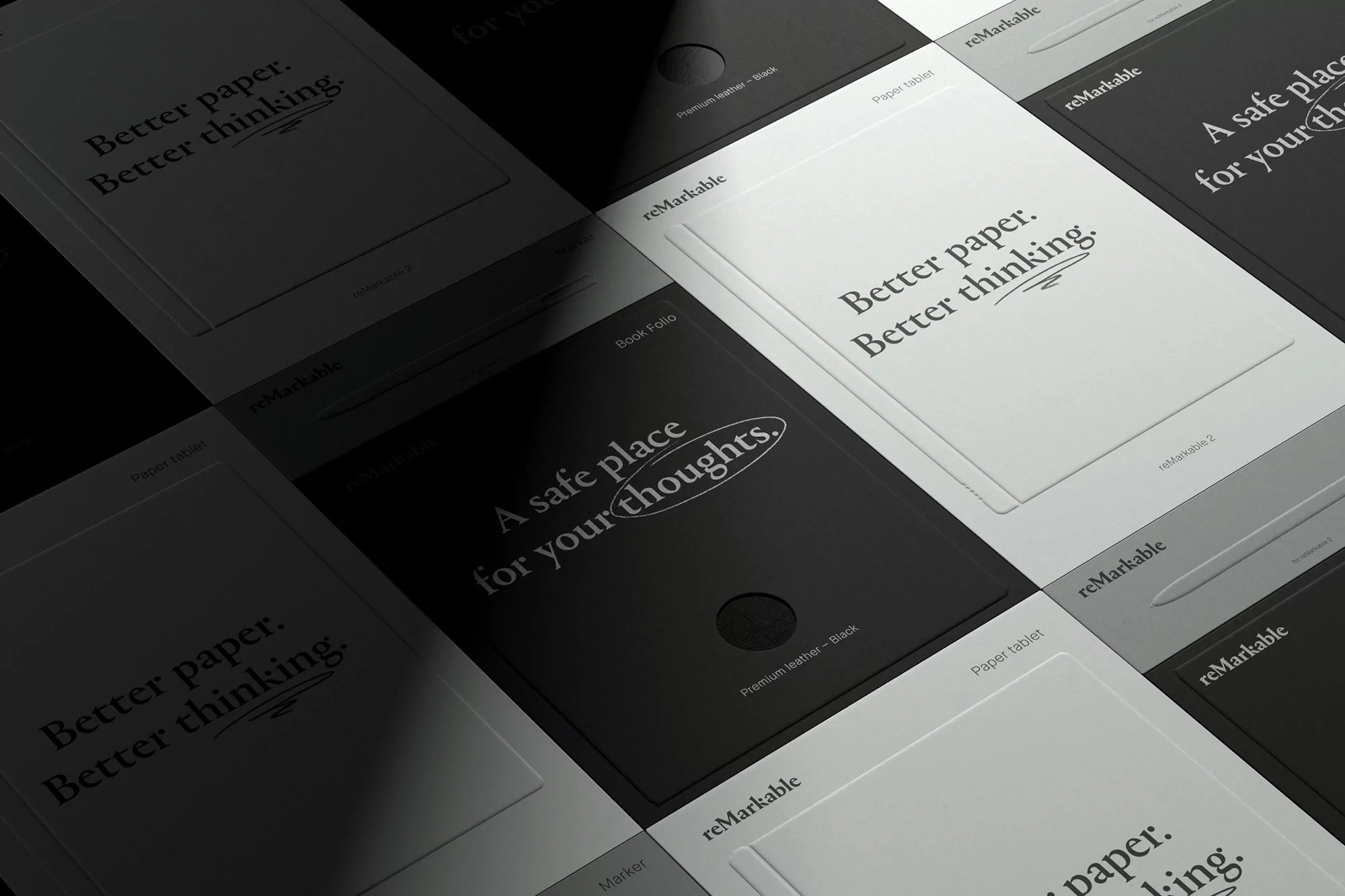 Several black and white Remarkable paper tablets arranged in a grid pattern, some with text on the screens and one with a pen.