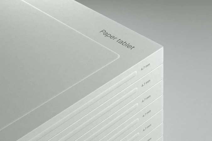 Stack of white paper tablets with minimalist design, showcasing clean lines, subtle typography, and a modern, neutral aesthetic.