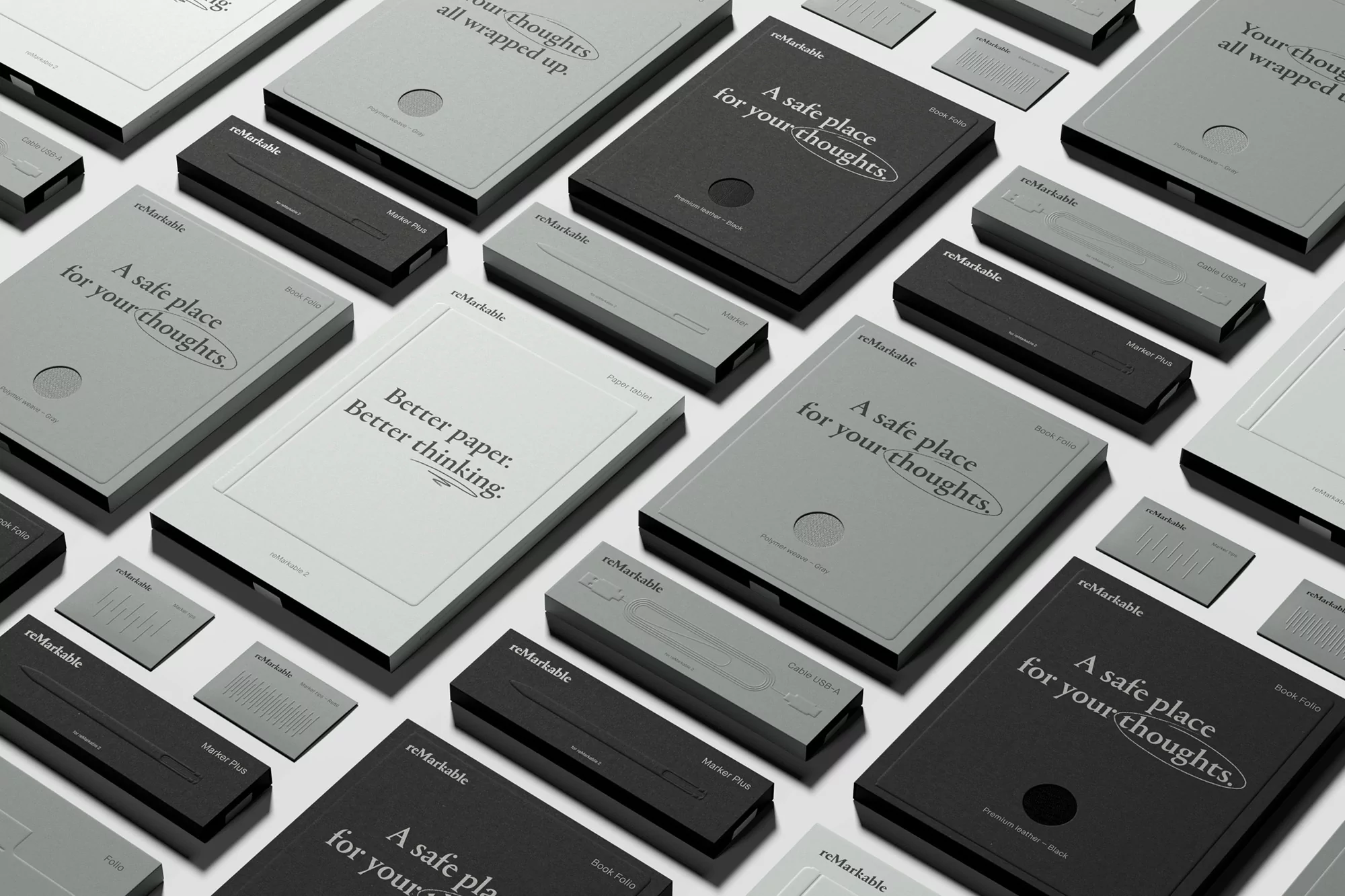 Monochromatic image featuring multiple reMarkable tablets and pen accessories in various grayscale shades on a neutral background. Product photography.