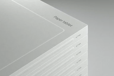 Close-up of a stack of slim white digital paper tablets showing 4.7 mm profile thickness and Paper tablet text.