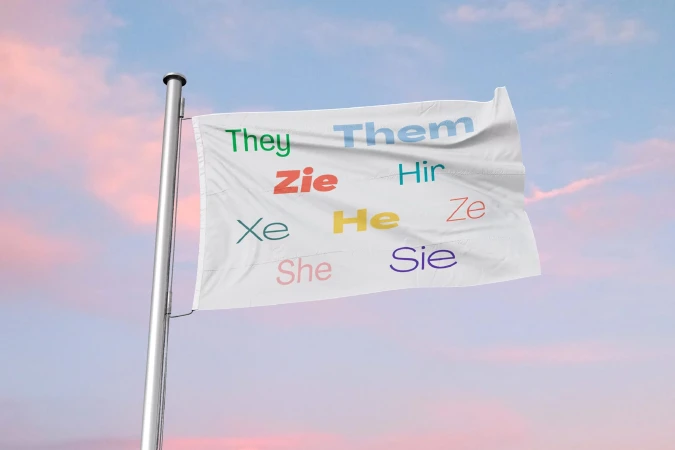 Flag with colorful pronouns 'They, Them, Zie, Hir, Xe, He, Ze, She, Sie' waving against a soft pastel sky with pink and blue hues.