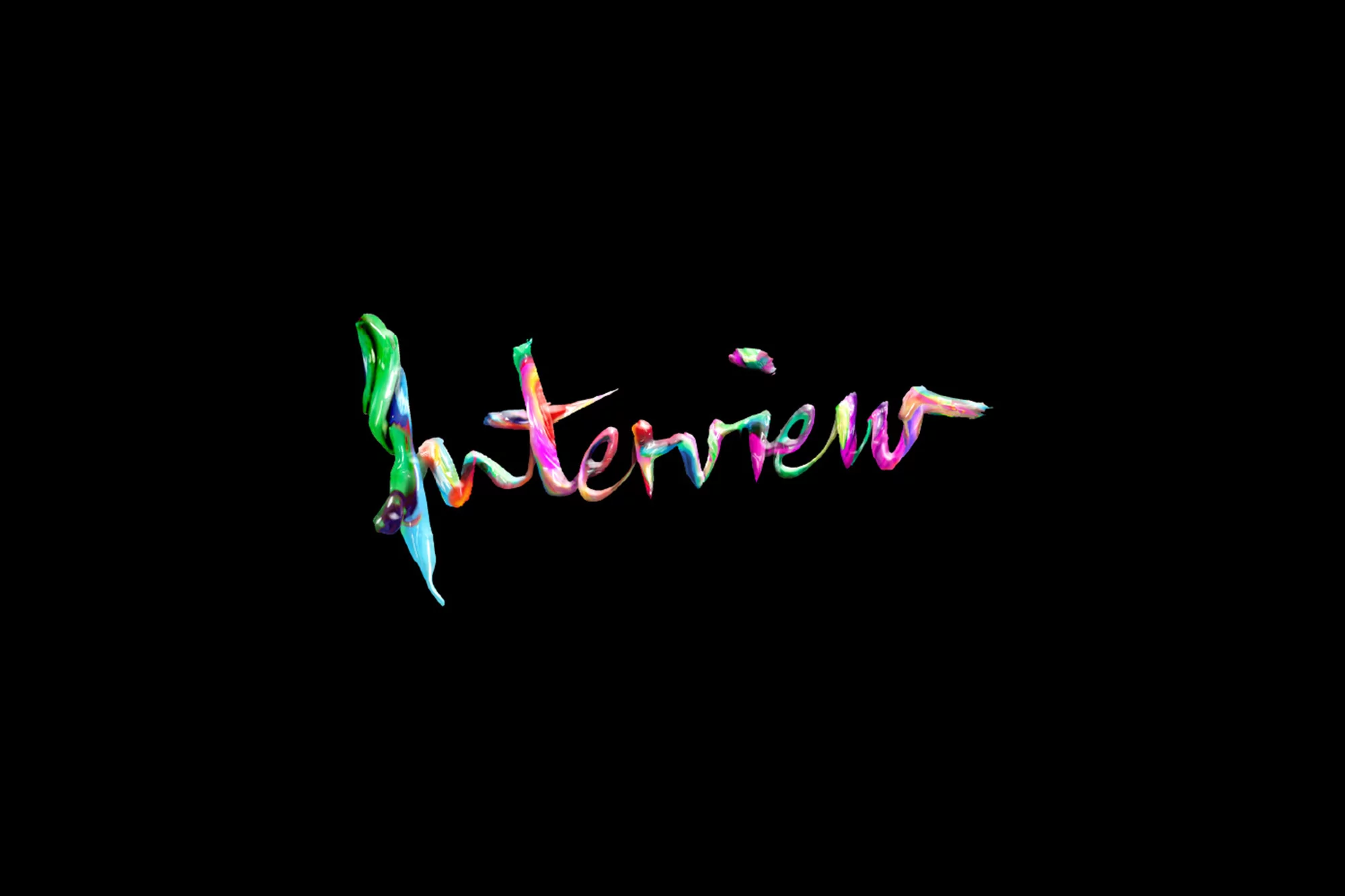 Colorful painted word "Interview" against black background. Abstract artistic lettering with vibrant green, red, blue, and pink hues.