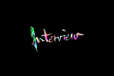 Multicolor glossy painted typography spelling Interview against a solid black background