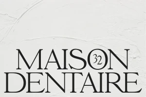 Black serif typography reading Maison Dentaire against a textured white background with subtle plaster brushstrokes