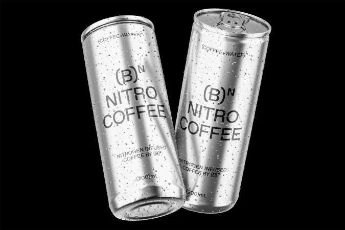 Two silver cans of Nitro Coffee are displayed against a black background, featuring water droplets and visible brand labeling.