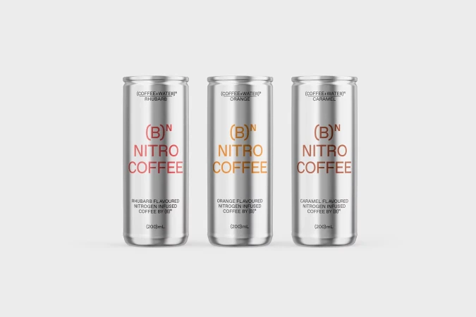 Three silver cans of (B) Nitro Coffee in Rhubarb, Orange, and Caramel flavors stand against a white background in a studio product shot.