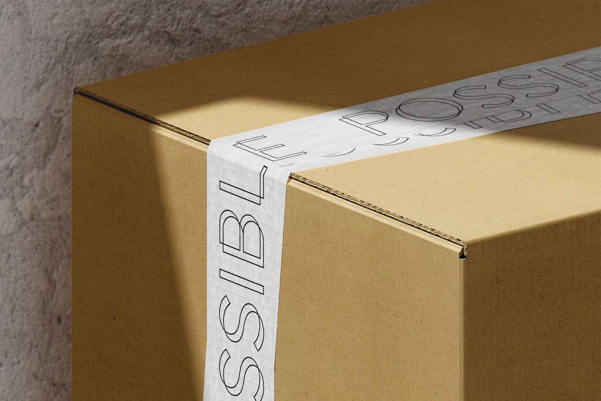 Close-up of a sealed cardboard box with white tape featuring black outlined text against a neutral gray wall, creating a simple packaging shot.