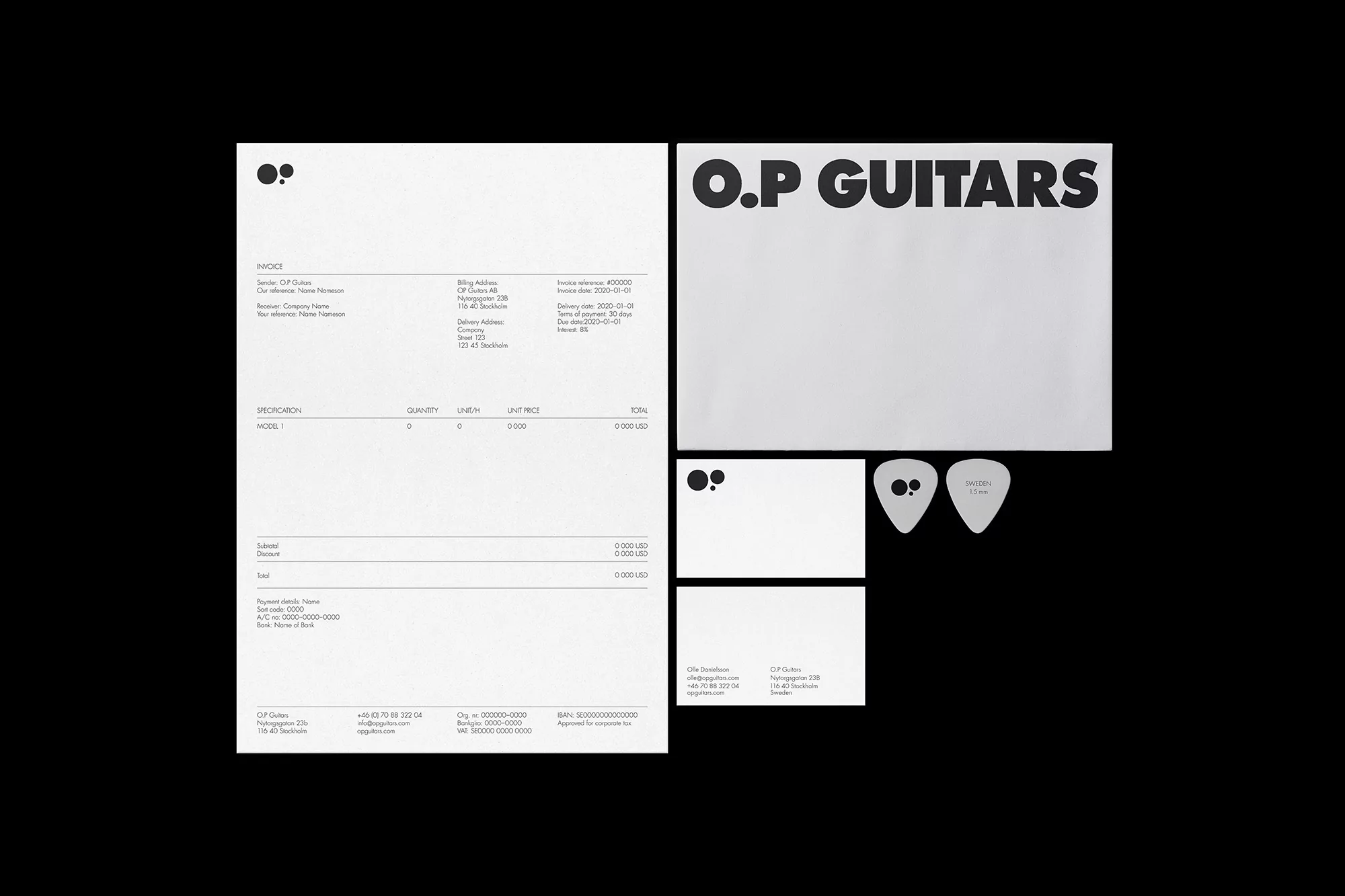 A flat lay photograph of O.P Guitars invoices, business cards, and guitar picks on a black background, in black and white.