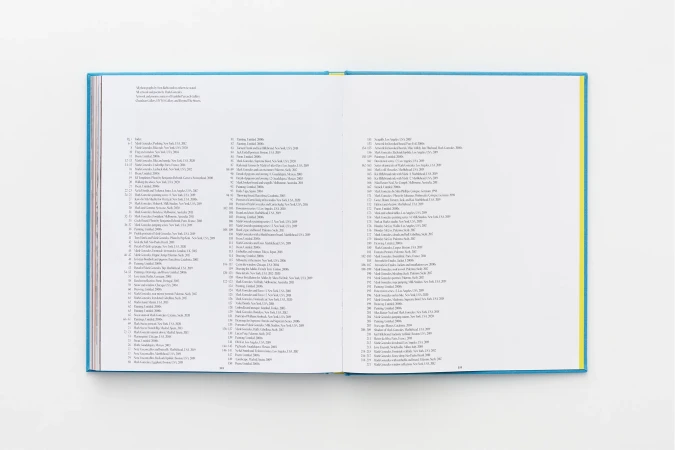 Open book on a white surface, showcasing two pages filled with dense text and a thin, light-blue and yellow binding.