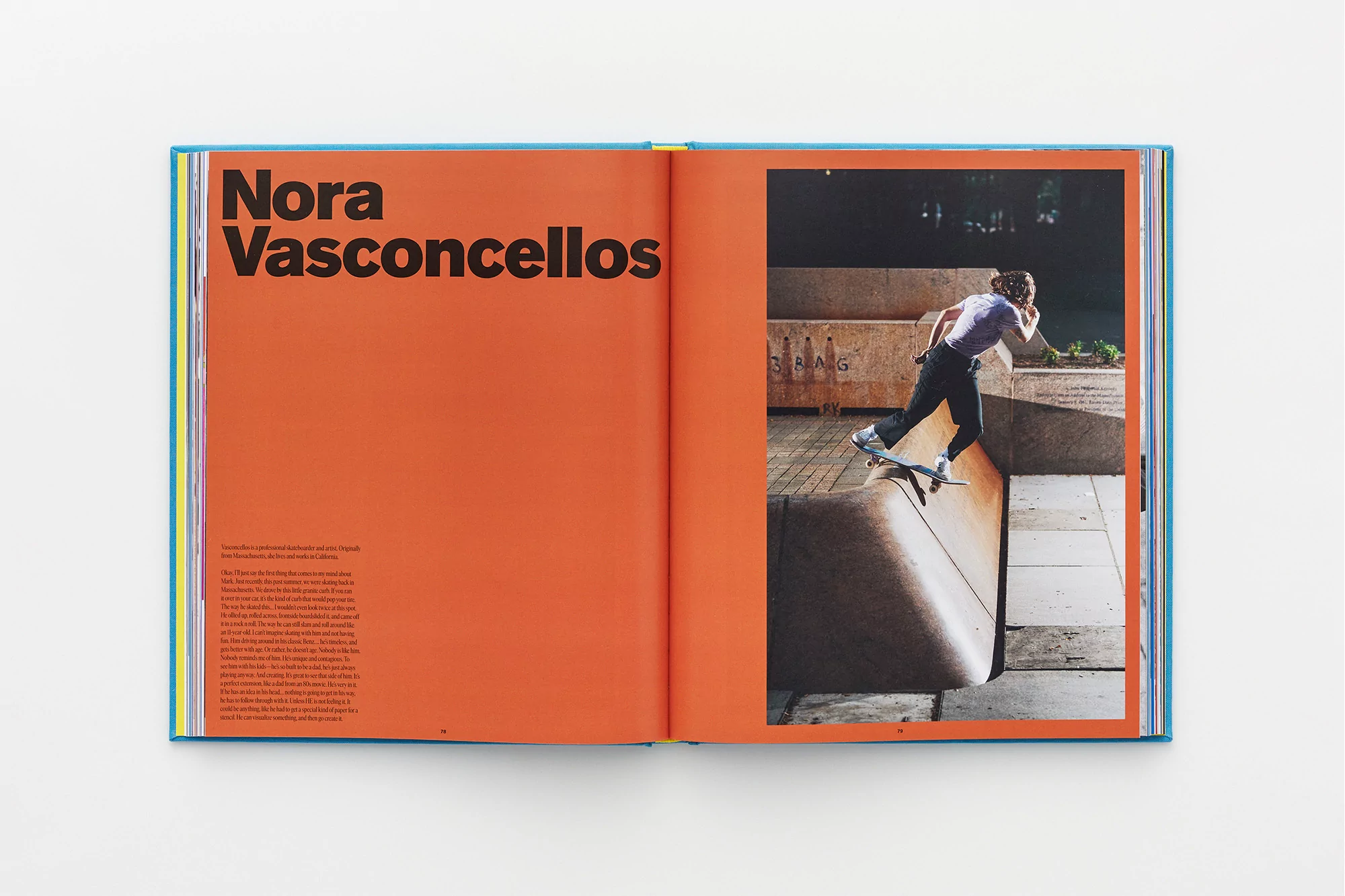 Open book spread featuring a photograph of Nora Vasconcellos skateboarding on a concrete surface, set against an orange background on the opposite page.
