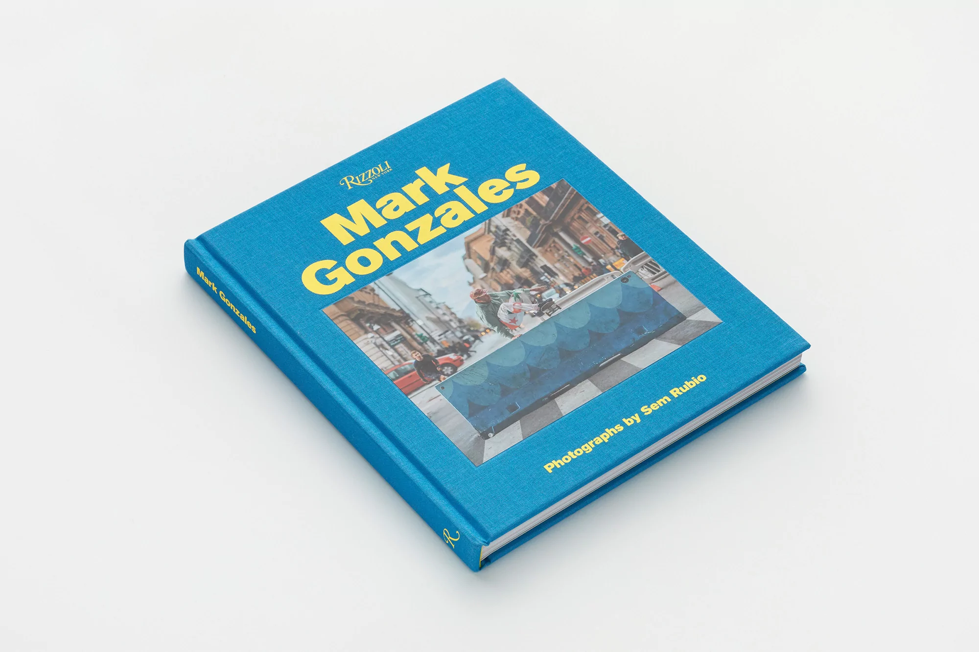 Blue hardcover monograph book for Mark Gonzales resting on a plain white background surface.