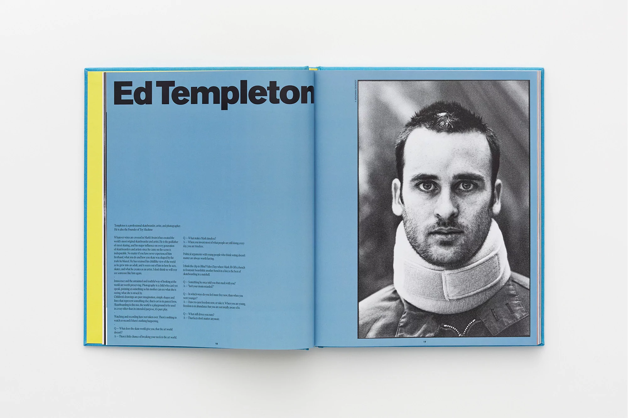 Open book with a black-and-white portrait of a man wearing a neck brace, next to a page with text on a light blue background.