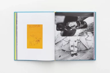 Open book layout displaying a yellow graphic page on the left and black-and-white photography on the right against a plain background