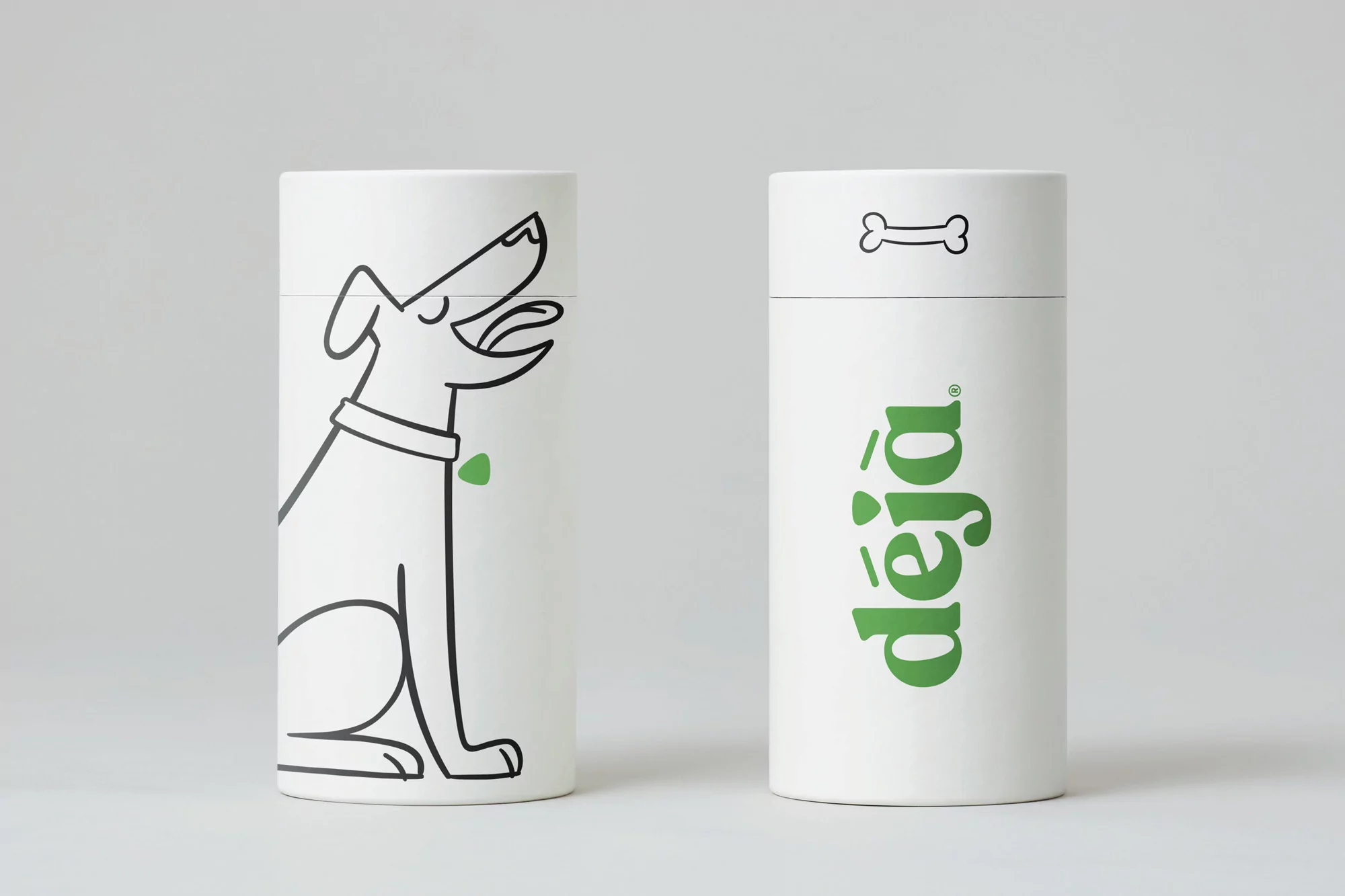 Two white cylindrical containers, one with a minimalist dog illustration, and the other with the word "déjà" and a dog bone symbol.