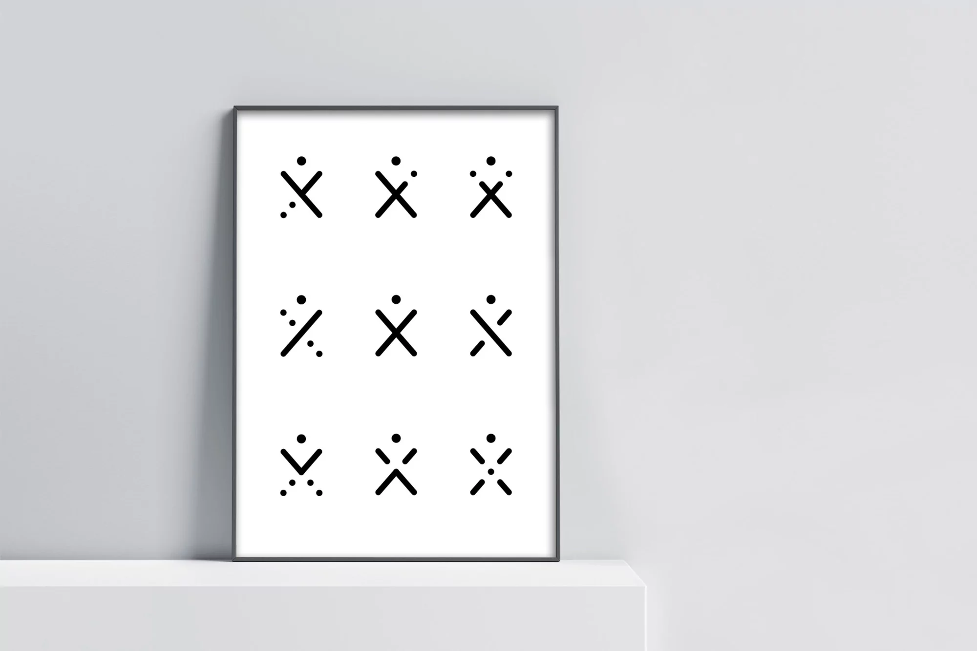 Black-and-white poster featuring geometric shapes in minimalist style, displayed on a shelf against a light gray wall, indoor shot.