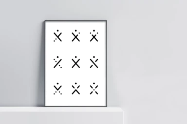 A framed graphic poster featuring a grid of minimal abstract black icons on a white background, resting on a white shelf.