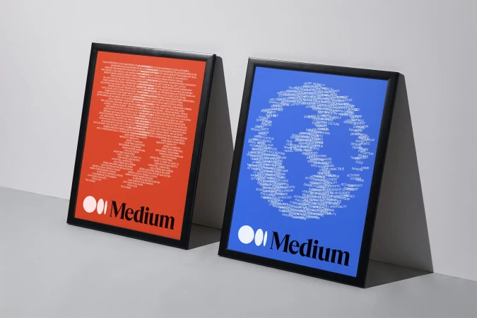 Two framed posters, one orange and one blue, each displaying a word cloud design of text arranged to resemble a face, with the 'Medium' logo.