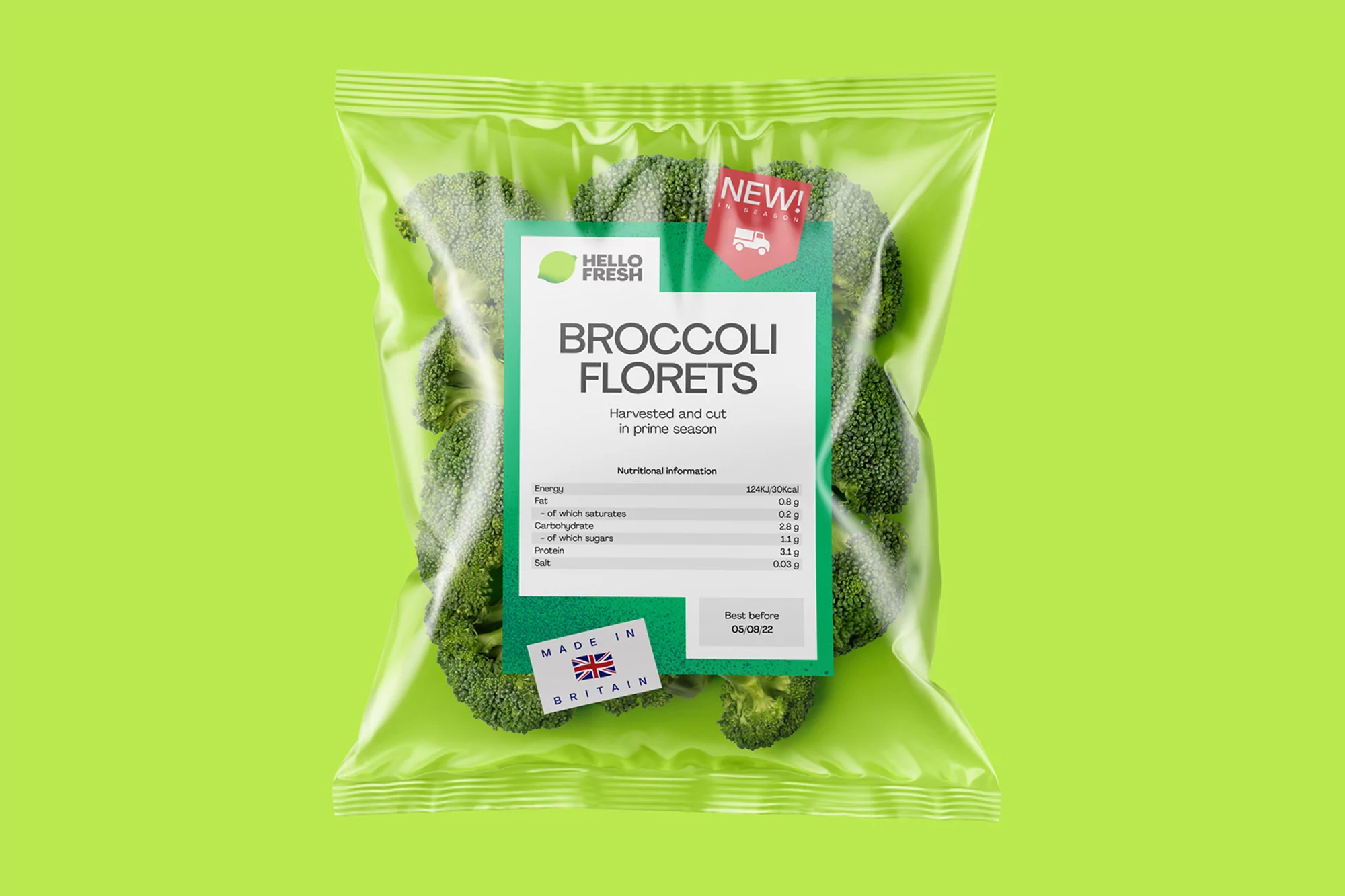 Package of fresh broccoli florets from Hello Fresh, sealed in clear plastic with a green label, on a bright green background.