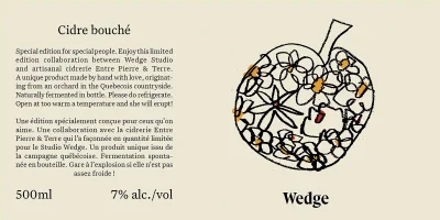 Illustrated line drawing of an apple filled with flower motifs alongside bilingual product text for Entre Pierre & Terre cider.