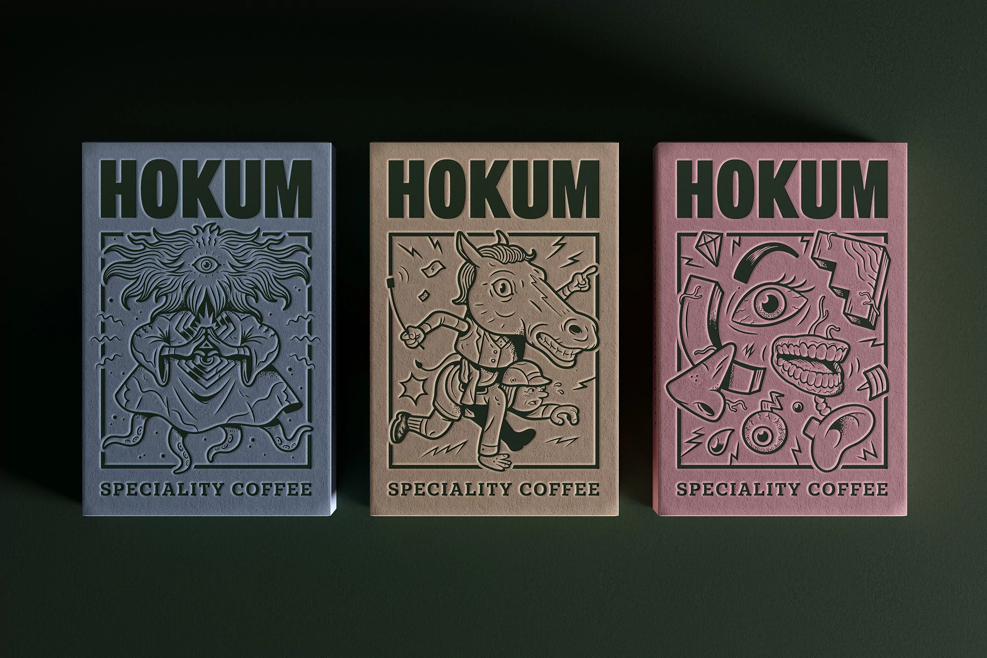 Three creatively designed coffee bags with unique illustrations stand side-by-side against a dark green backdrop, showcasing Hokum Speciality Coffee.