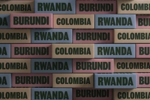 A patterned wall composed of colored rectangular blocks displaying country names in bold lettering for Hokum.