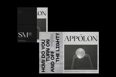 Folded printed sheets with typography and product imagery featuring a glowing sphere held by transparent stands against a black background