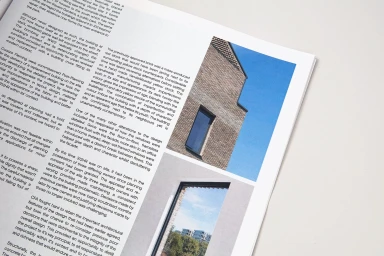 Printed pages from a brand identity booklet featuring architectural photography and text layout on white paper.