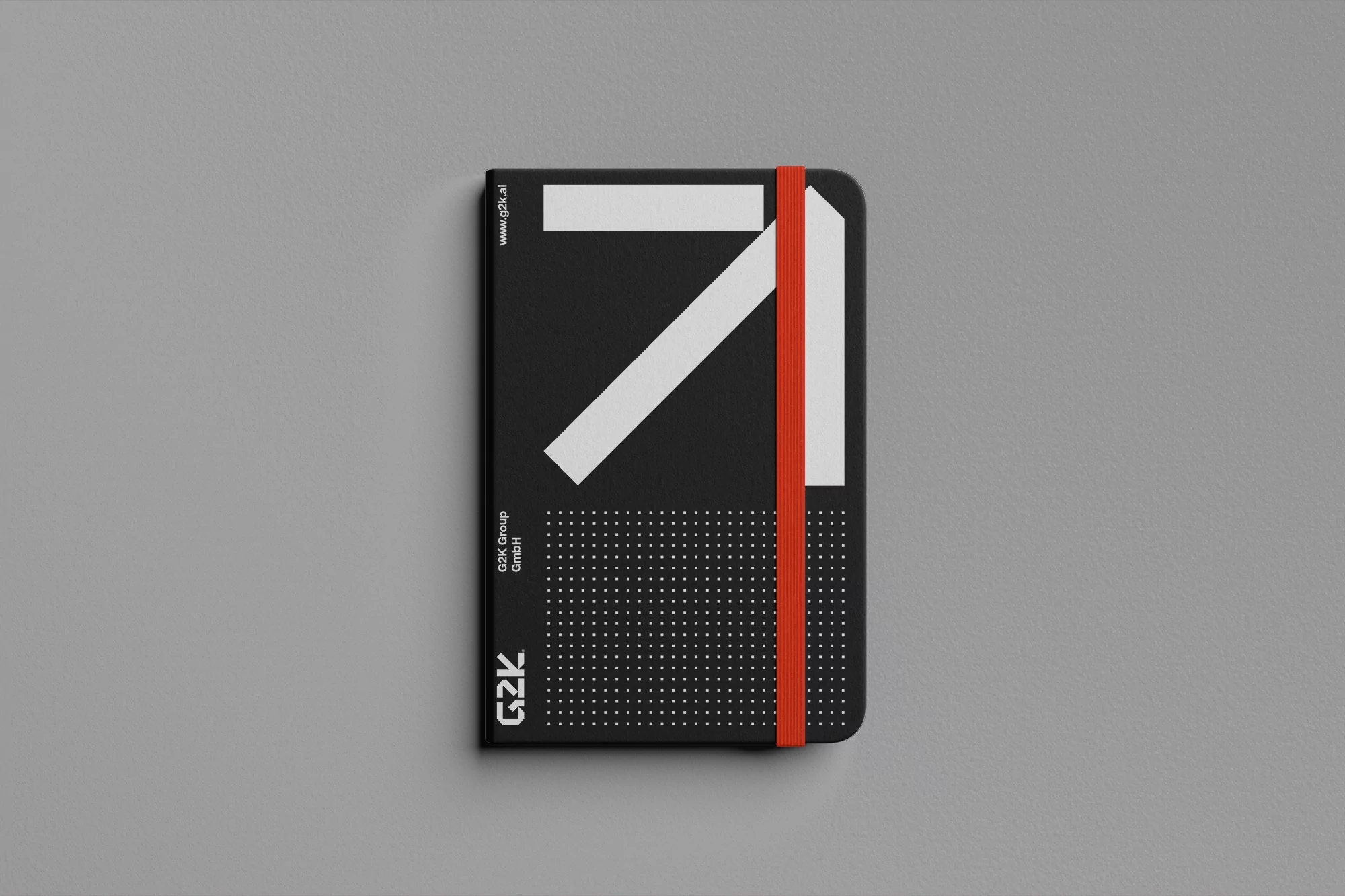 Black notebook with white geometric design and orange elastic band closure, centered on a light gray background. Minimalist design.