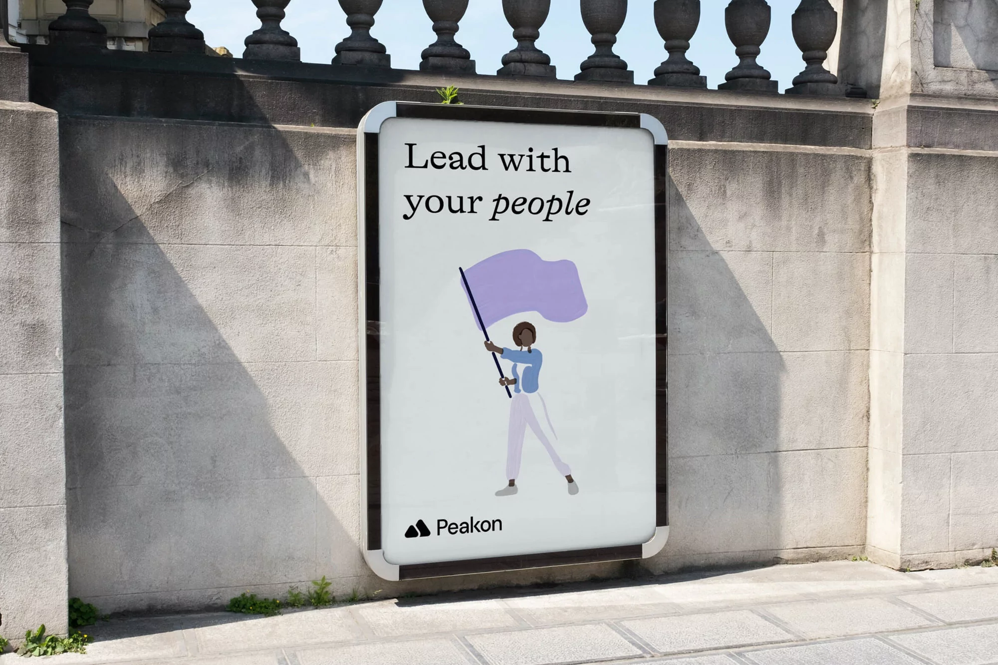 Outdoor advertising billboard showcases a digital art illustration of a woman holding a flag and the text, 'Lead with your people'.