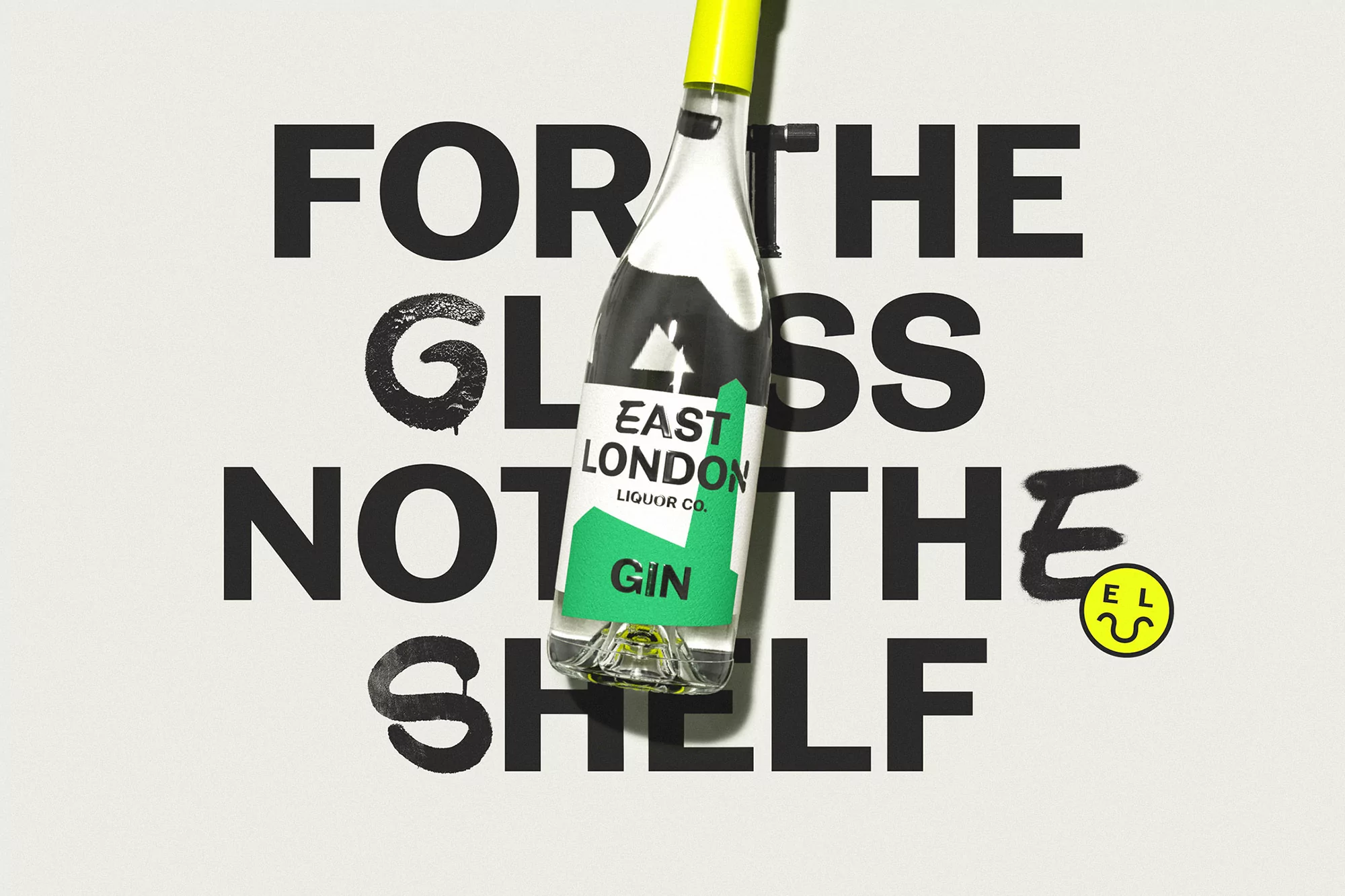 Gin bottle from East London Liquor Co. against an off-white background with black text that reads 'For the glass, not the shelf'.