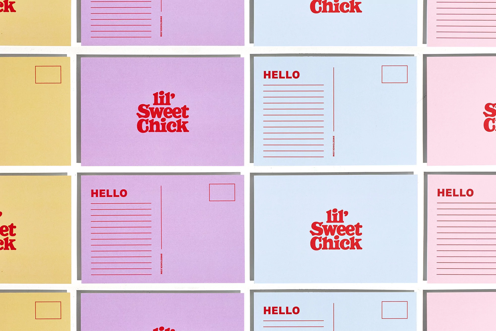 Colorful arrangement of postcards with 'Hello' and 'lil' Sweet Chick' in red font, creating a vibrant and cheerful stationery display.