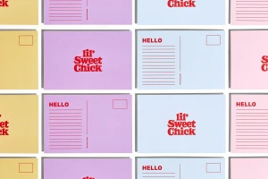 Flat lay grid of pastel postcards with red typographic branding and address lines on a clean white background