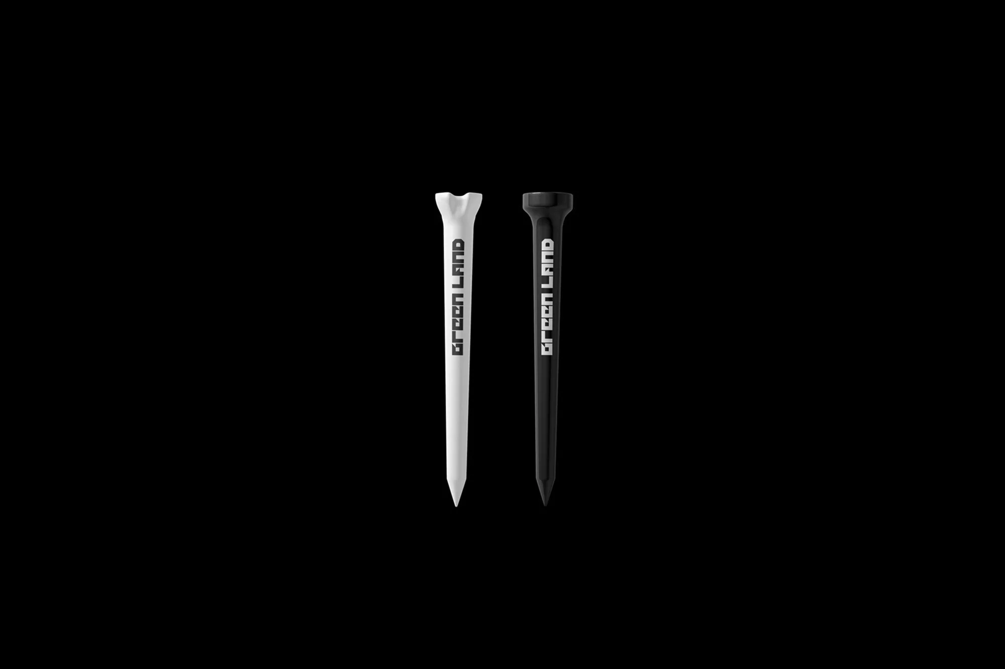 Two golf tees, one black and one white, stand side-by-side against a stark black background, displaying the brand 'Green Land'.