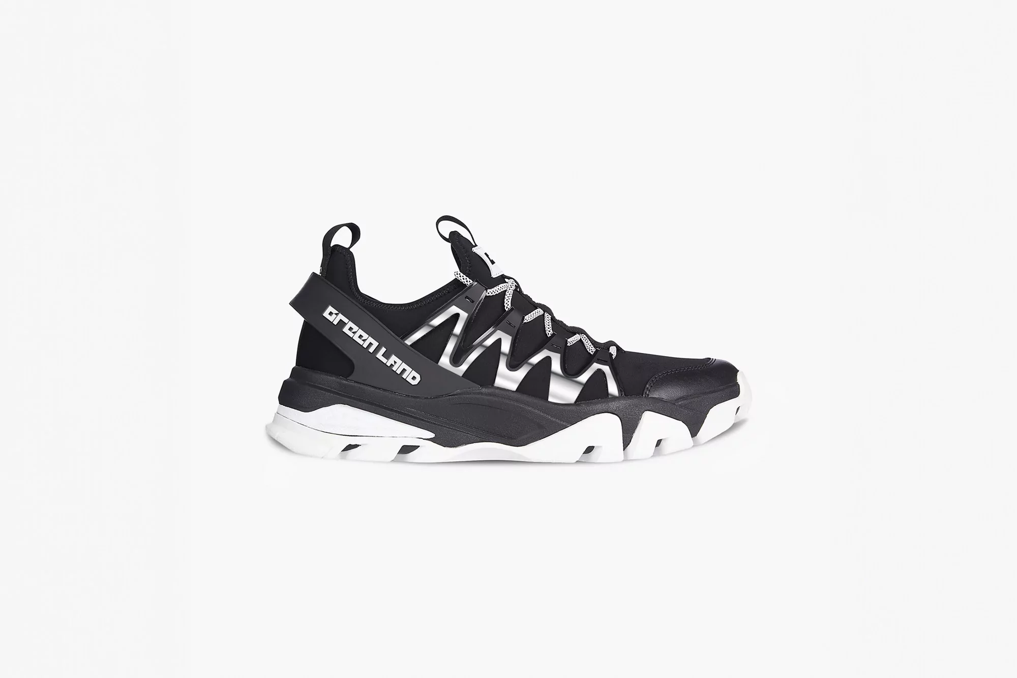 Black and white 'Green Land' sneaker on a white backdrop. Features a lug sole, lace-up closure, and the brand name on the side.