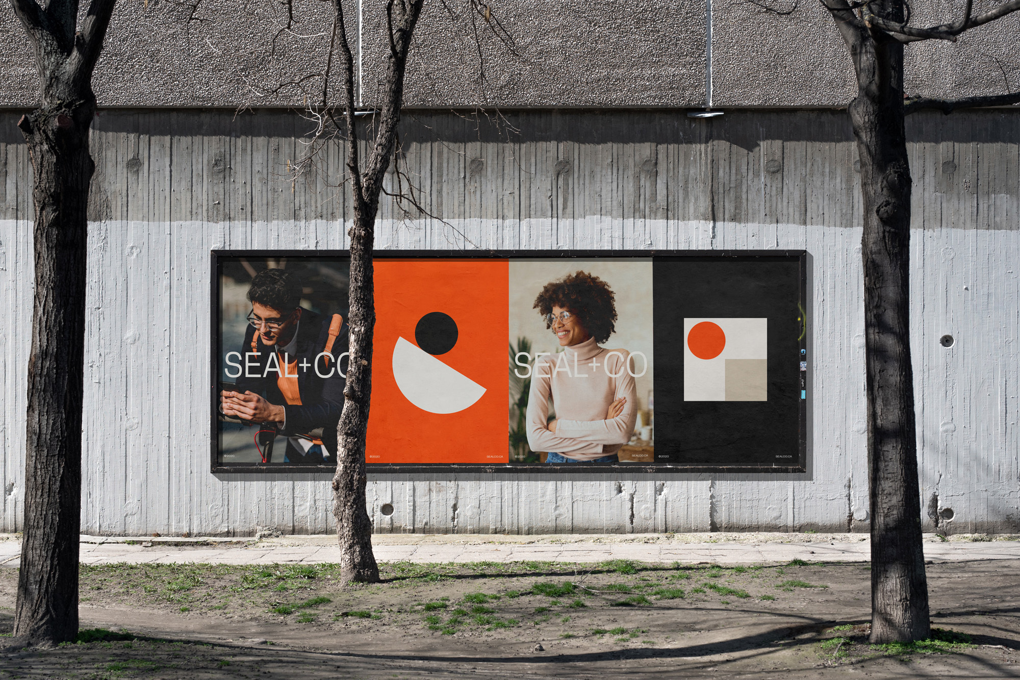 Outdoor advertisement for SEAL+CO featuring a man and a woman on a concrete wall, framed by trees in an urban environment.