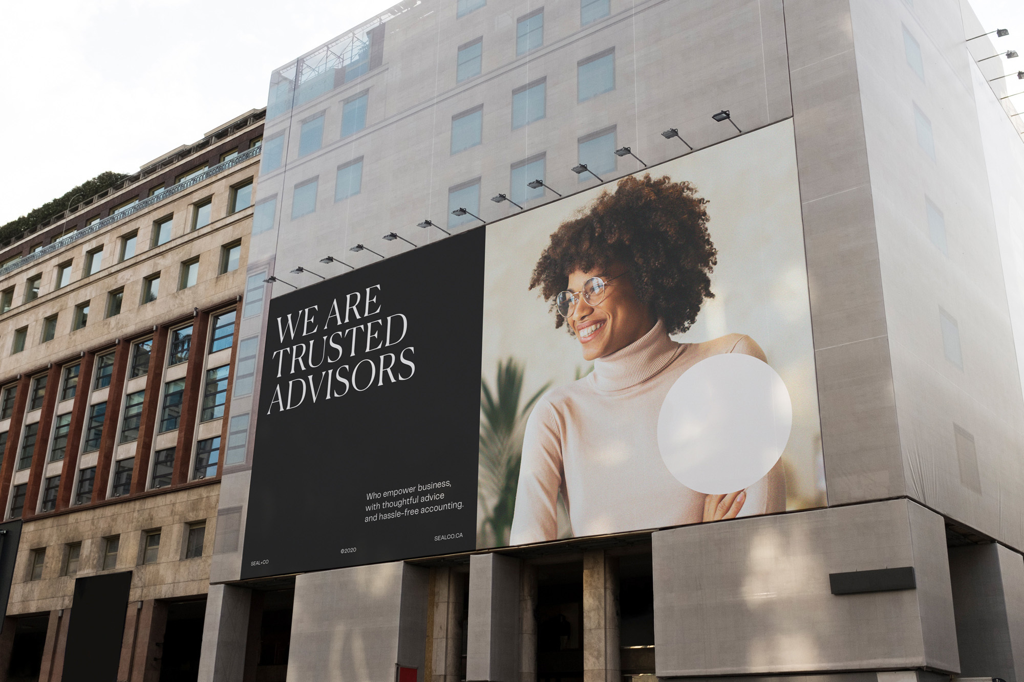 Outdoor billboard features an Afro-Caribbean woman in a commercial advertisement for financial advisors set against an urban building facade.