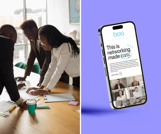Two African-American professionals discuss a project. Next to them, a phone displays a Zoom-like interface with people on screen.