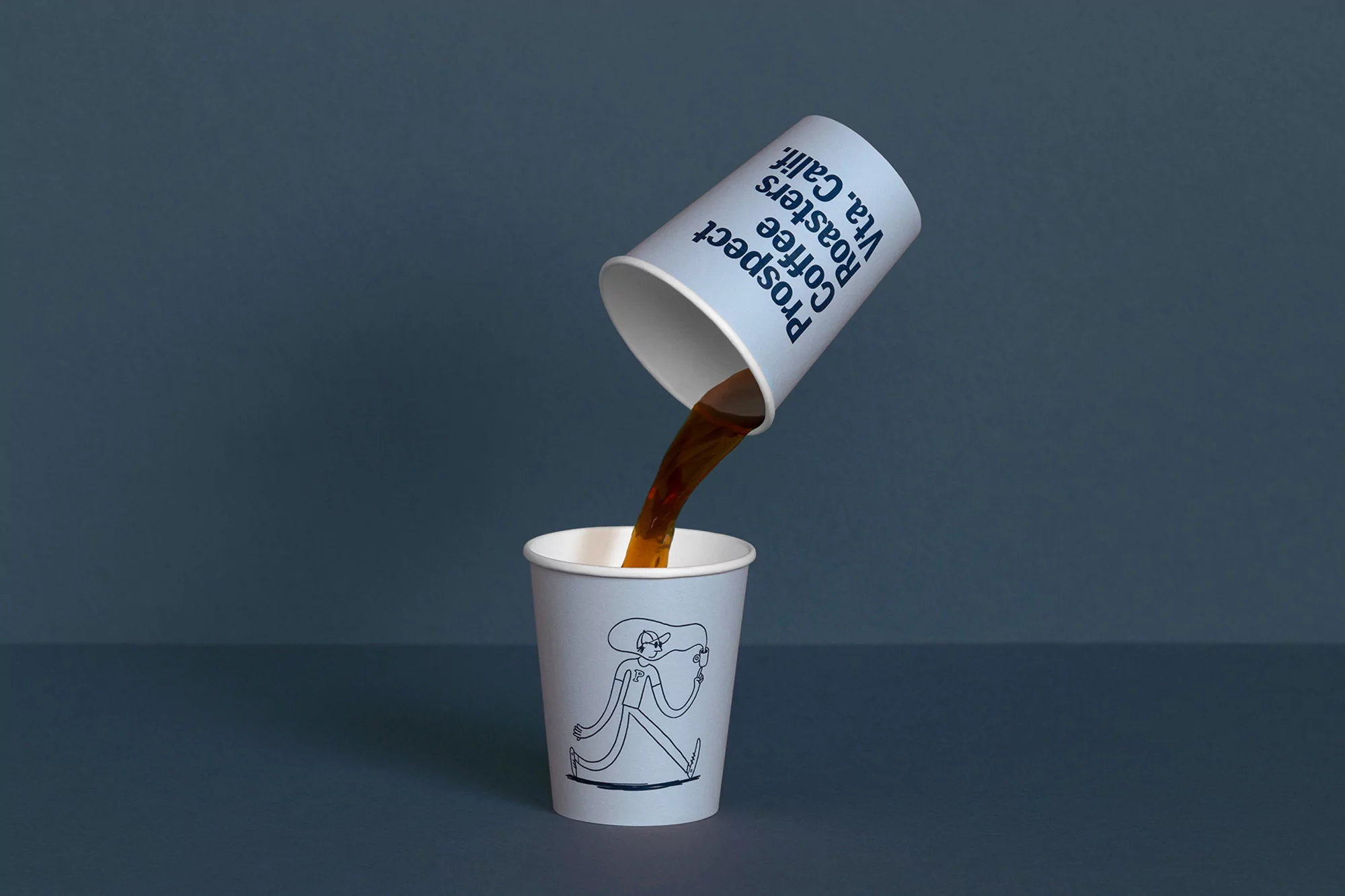 Coffee being poured from a cup labeled 'Prospect Coffee Roasters Vta. Calif.' into a matching cup with a line art illustration.