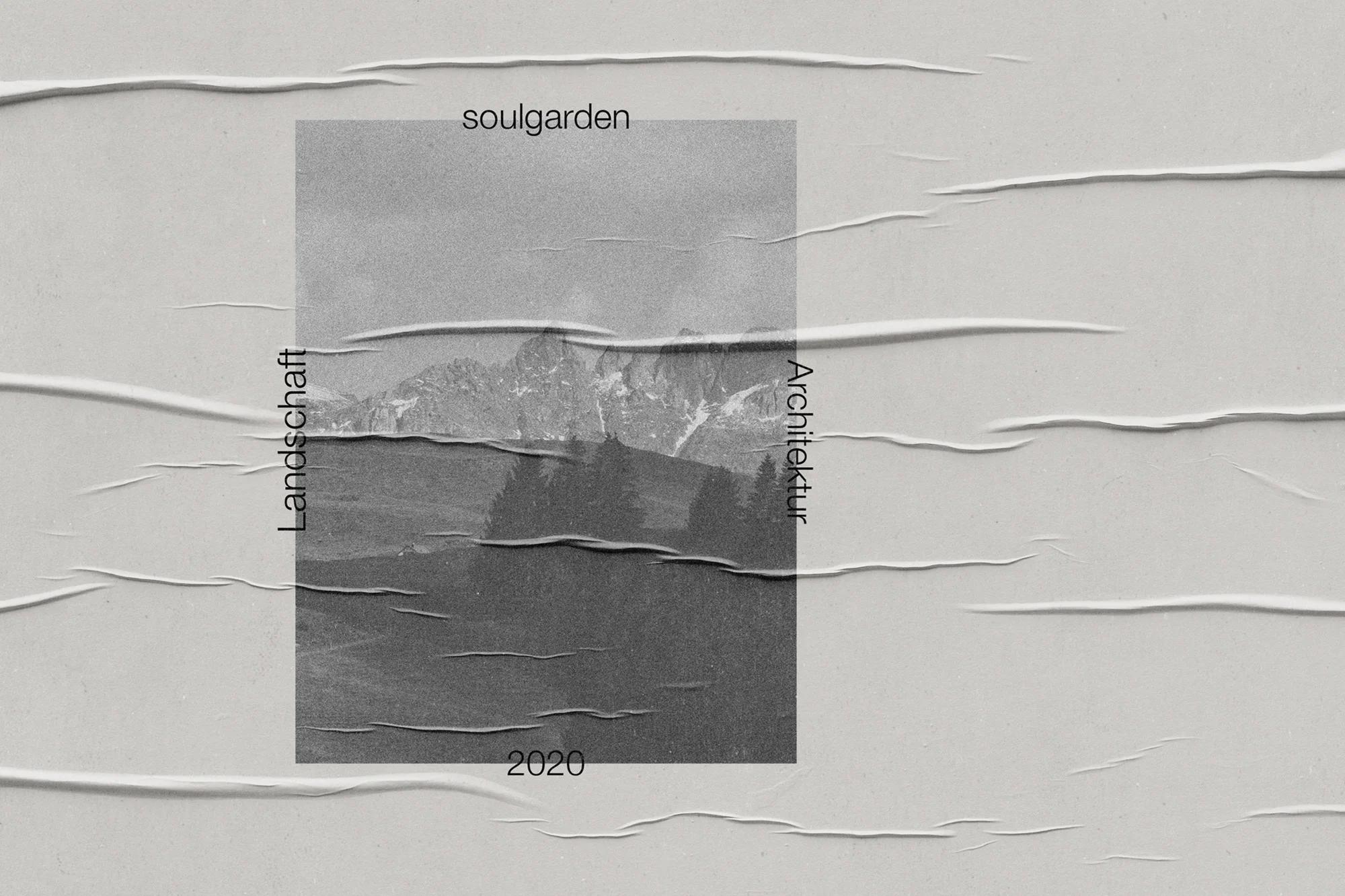Poster featuring a monochrome landscape with mountains, trees, and text, adhered to a textured gray surface with creased edges.