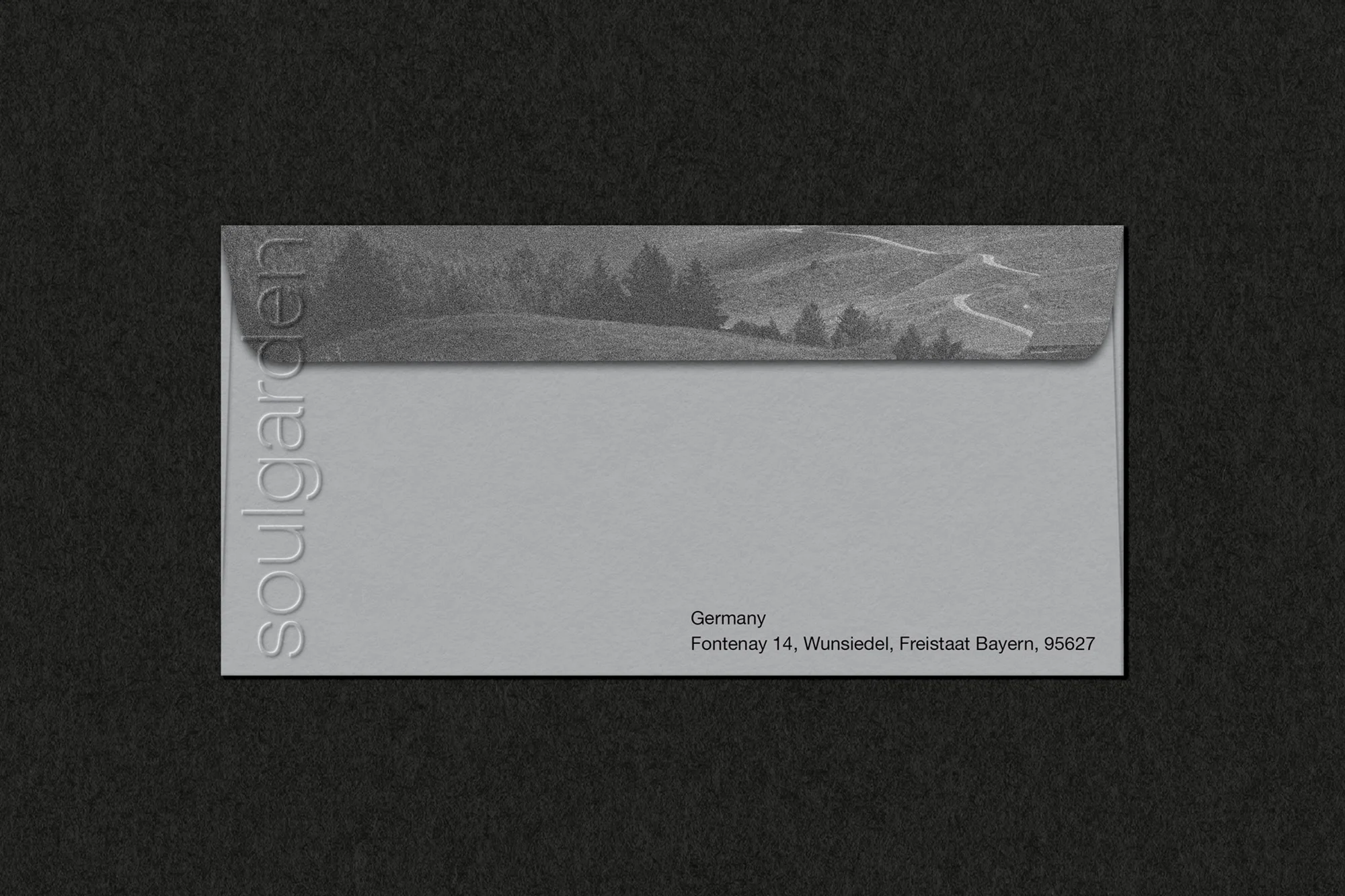 Envelope with landscape graphic and text 'soulgarden' against a black background. Mailing address in Germany is visible.