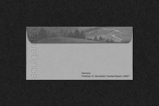 Envelope with landscape graphic and text 'soulgarden' against a black background. Mailing address in Germany is visible.