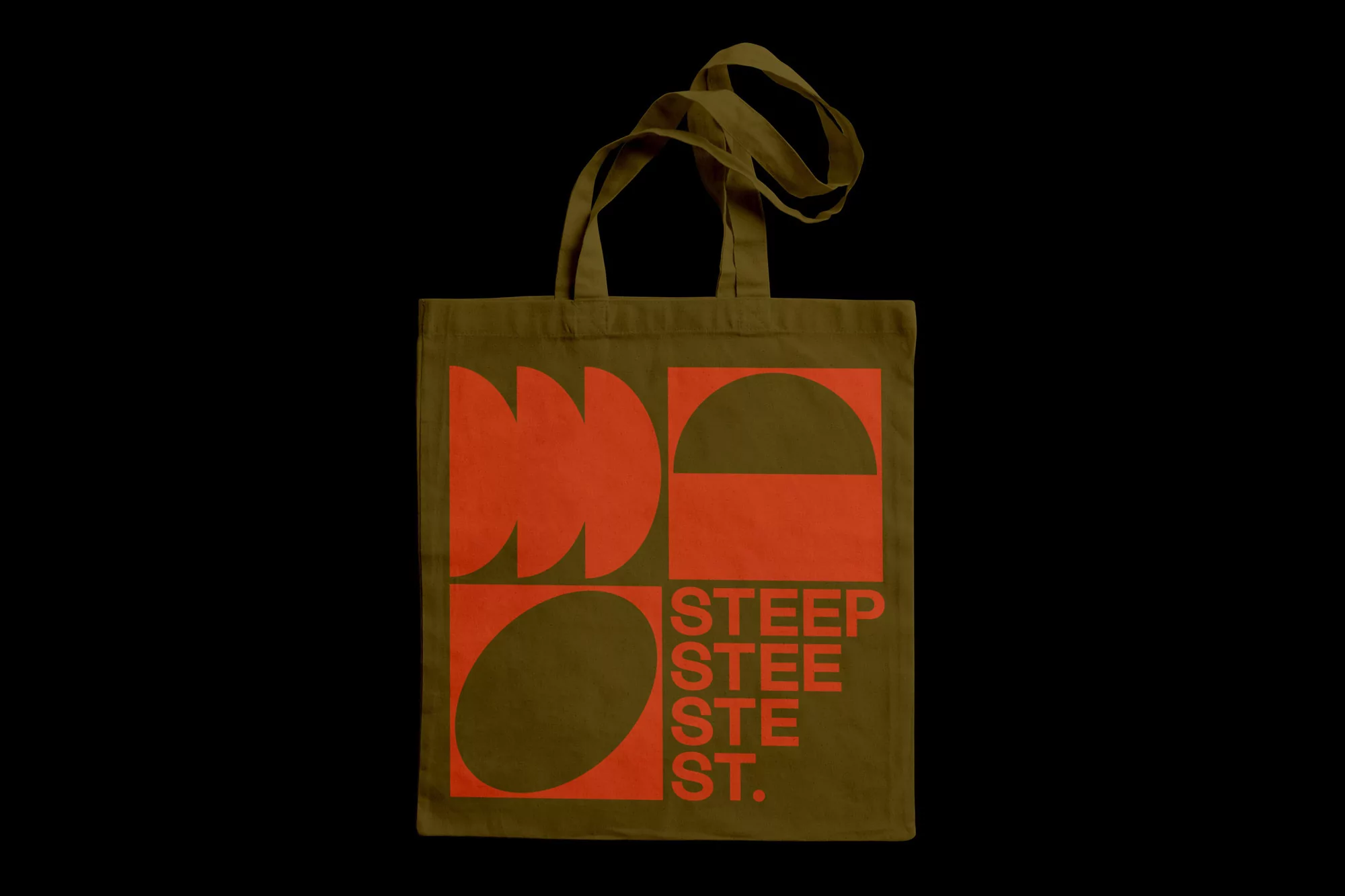 Olive green tote bag featuring orange geometric design and text, ideal for shopping or carrying everyday items against a black background.