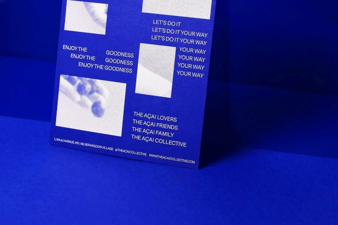 Promotional material with acai-themed graphics and text, including phrases like 'Enjoy the Goodness' and contact details on a blue background.