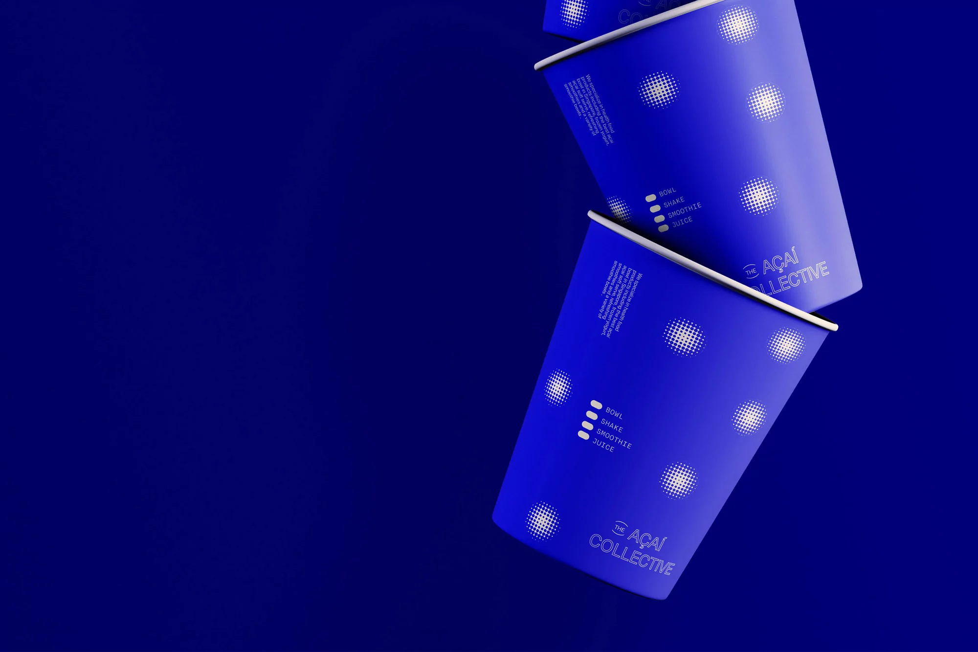 Two blue paper cups with white graphics featuring the 'Acai Collective' logo and text for 'Bowl, Shake, Smoothie, Juice'.
