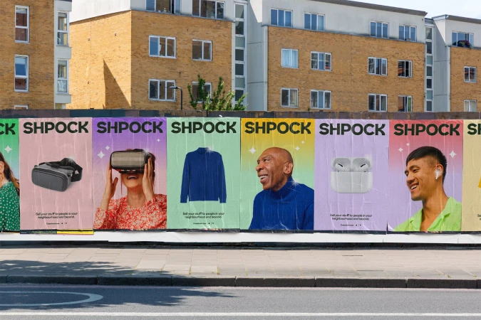 Outdoor view of a Shpock advertising campaign featuring posters of virtual reality headsets, clothing, earbuds, and people.