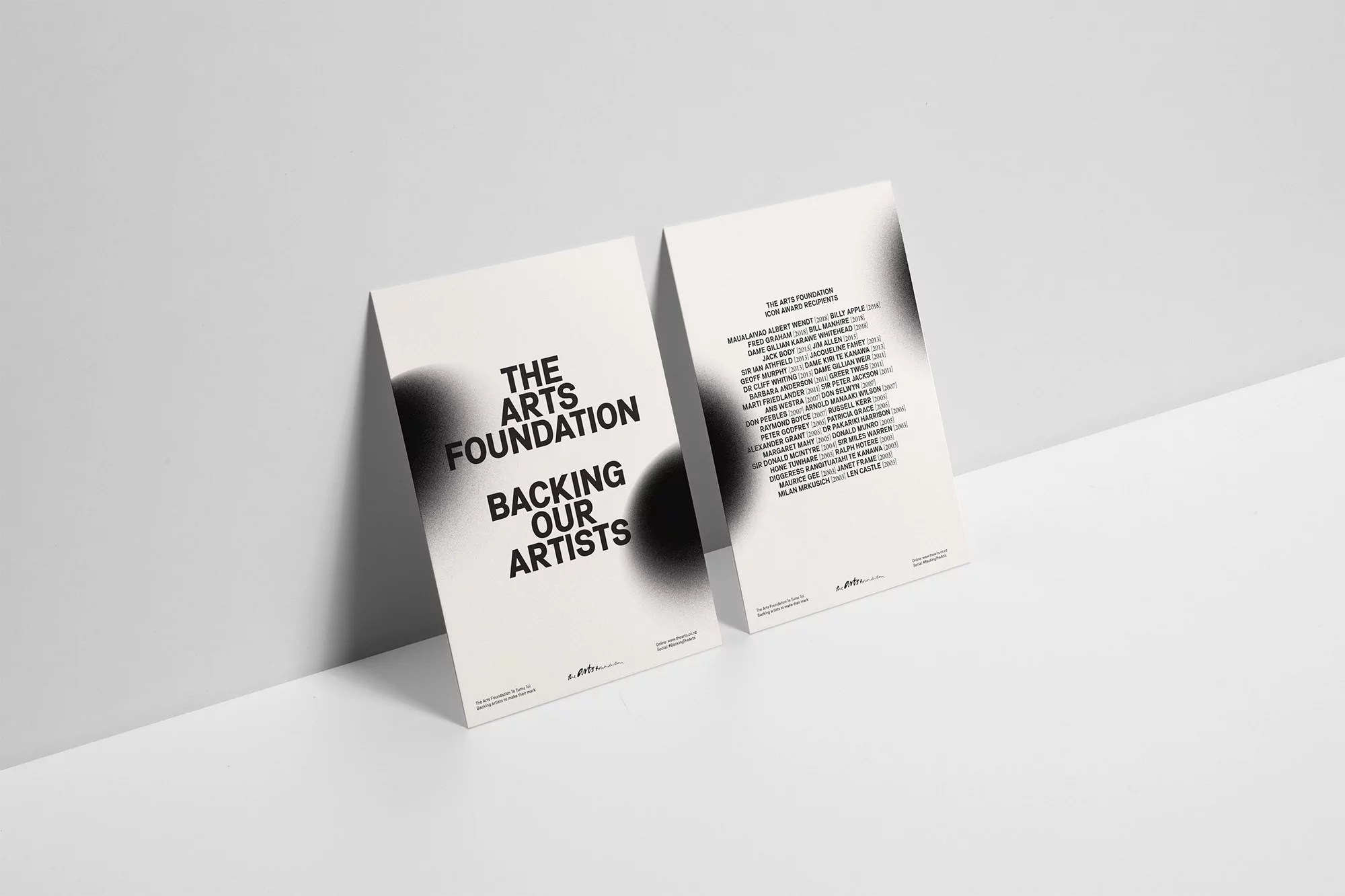 Two vertically-oriented posters featuring 'The Arts Foundation' text on a white surface against a gradient-lit white background.